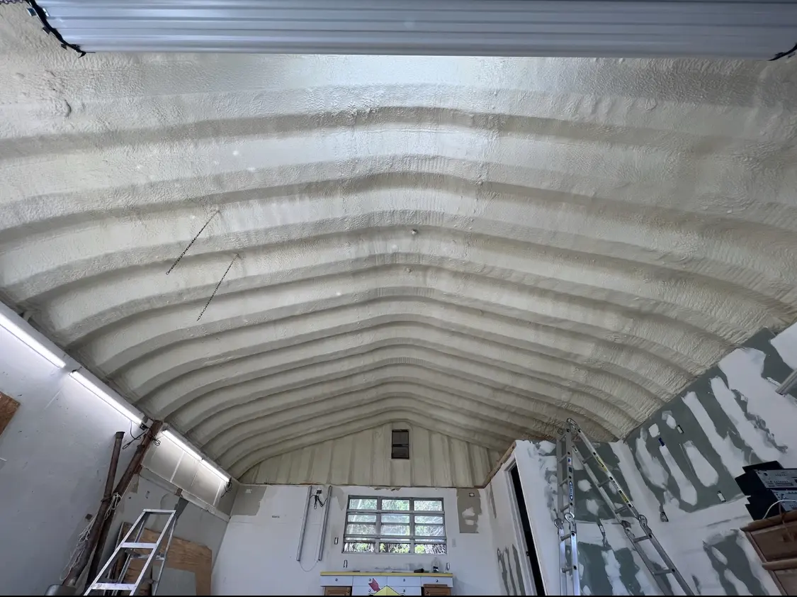 Spray polyurethane foam applied to the underside of a metal roof deck in Long View